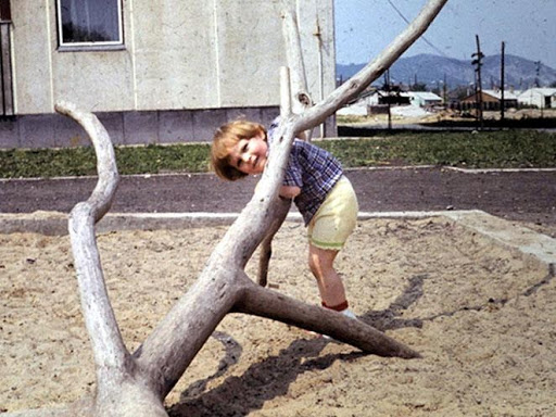 Archive photo of child playing at a playground in the 70's in Őrmező